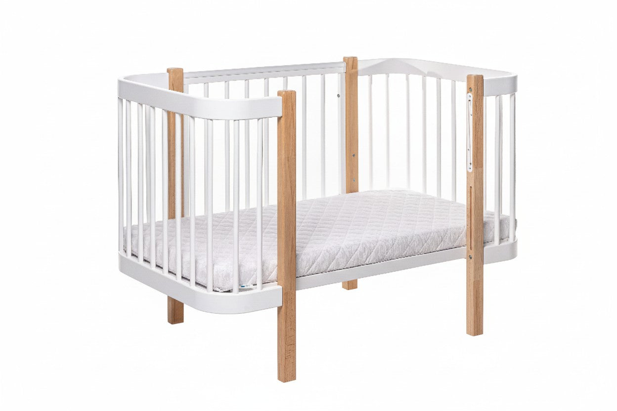ELIN baby crib in toddler mode showing lower mattress position for growing children