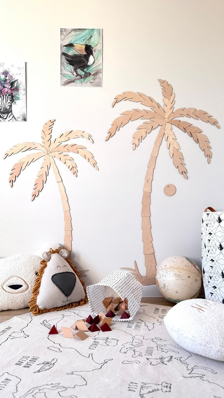Complete room view showing wooden palm tree set installed above nursery play area
