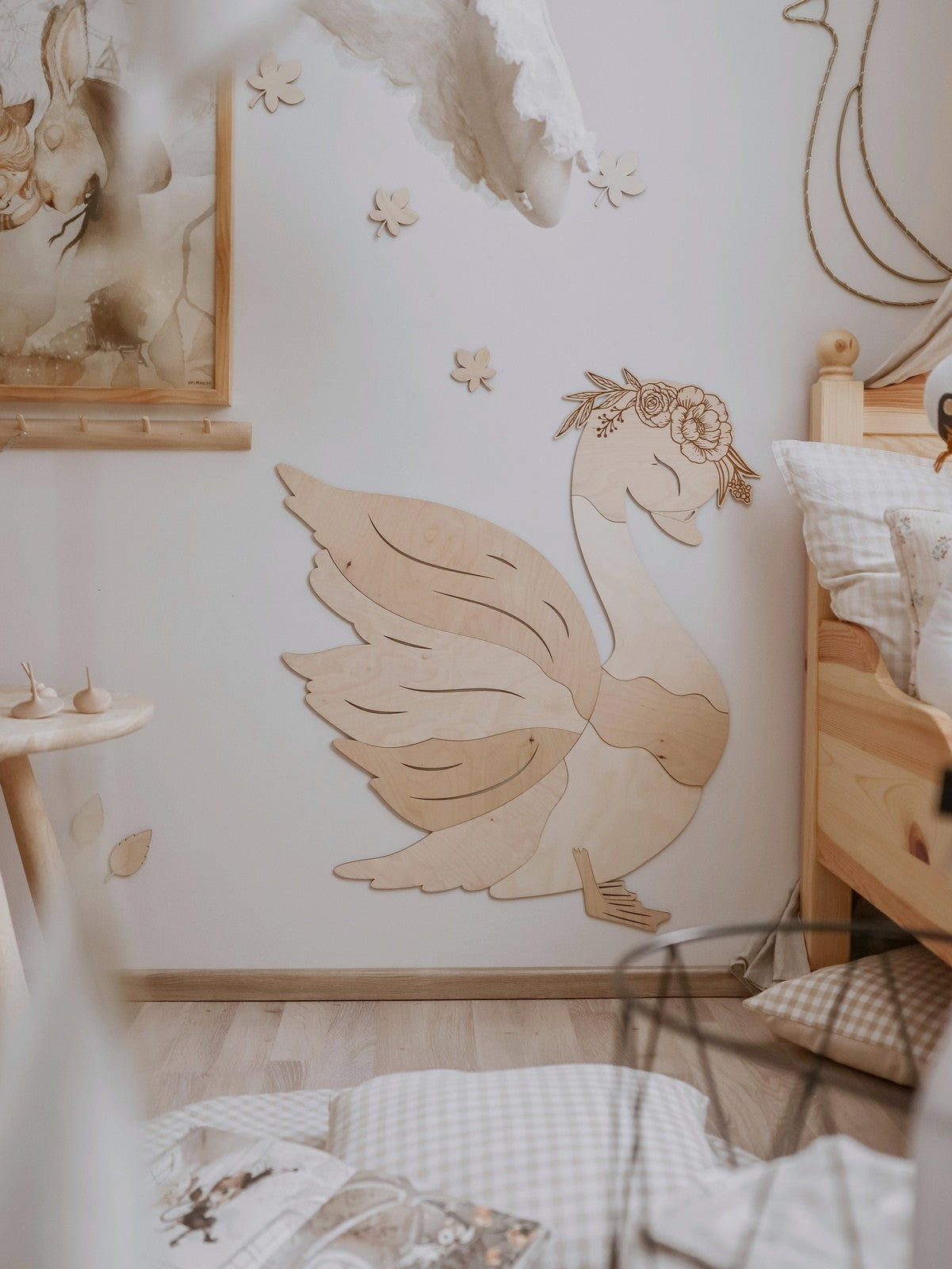 Full wooden swan wall decoration displayed in nursery with coordinating wooden furnishings and decor