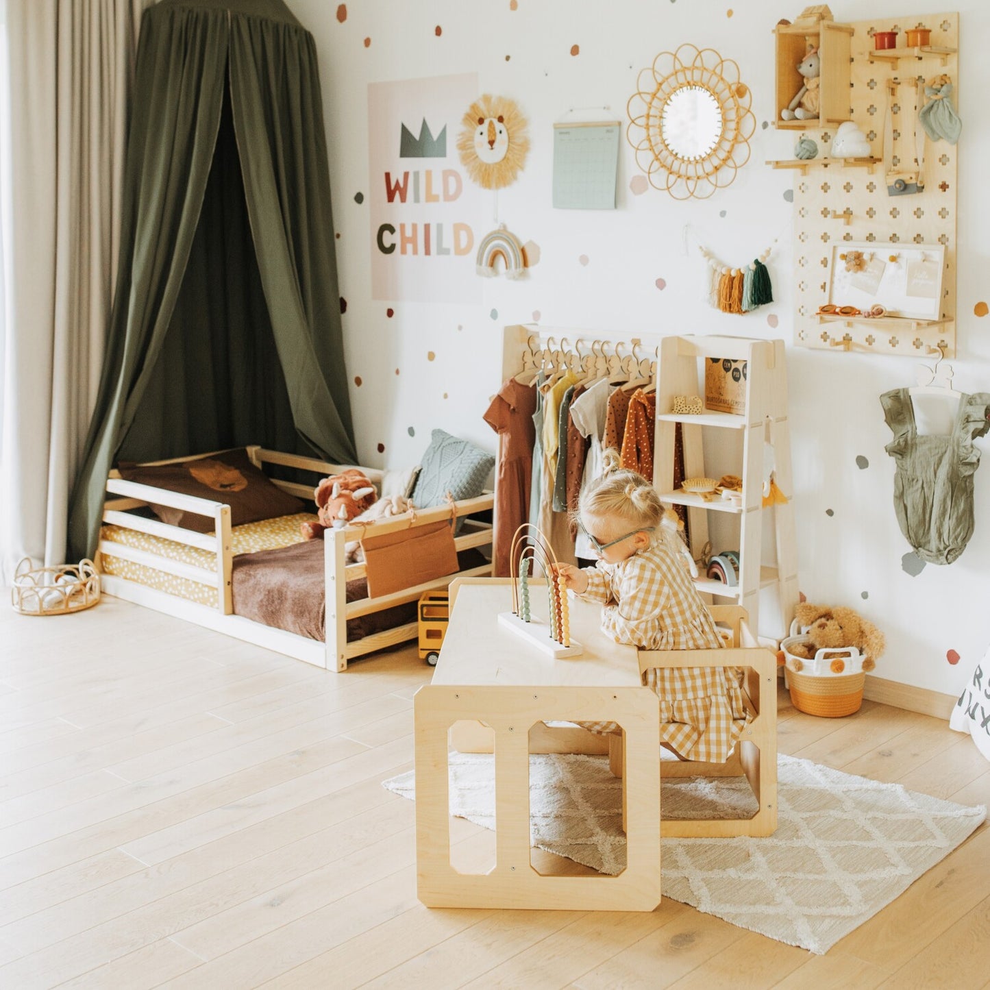 Natural birch Montessori table and chair in playroom with Montessori house bed