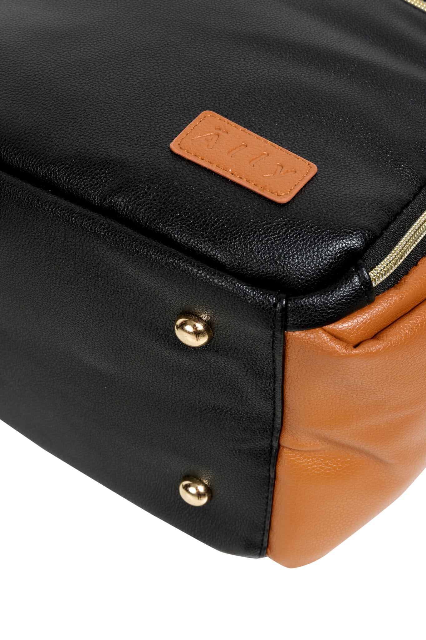 Bottom corner detail showing tan vegan leather accent with gold stud hardware on black bag