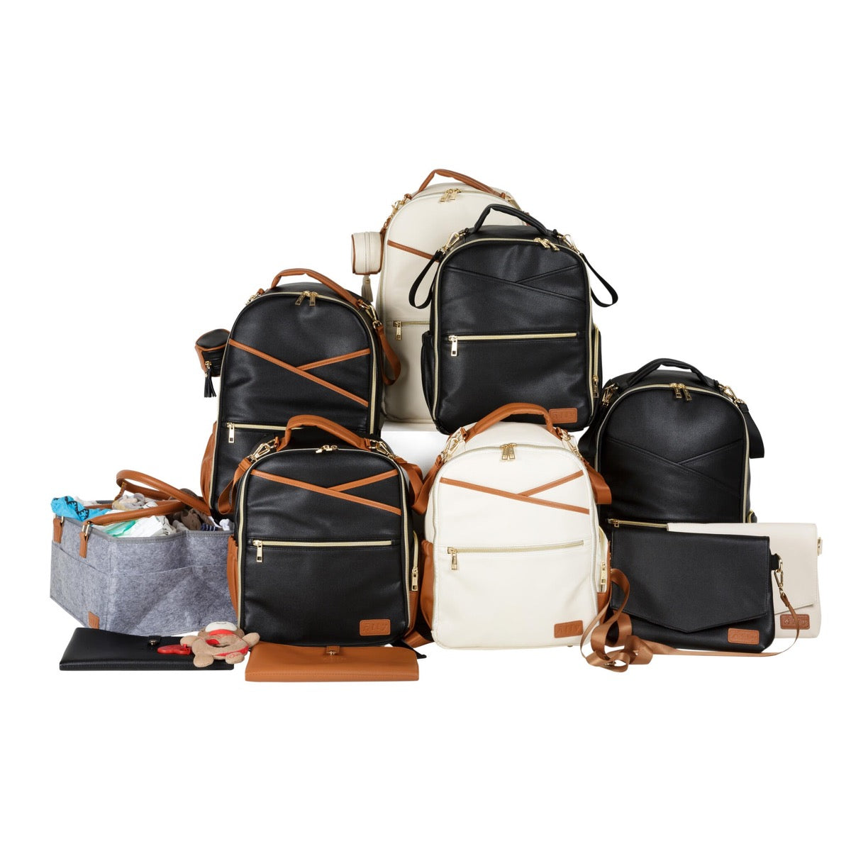 Ally Scandic collection of black, cream and beige baby backpacks and handbags displayed together