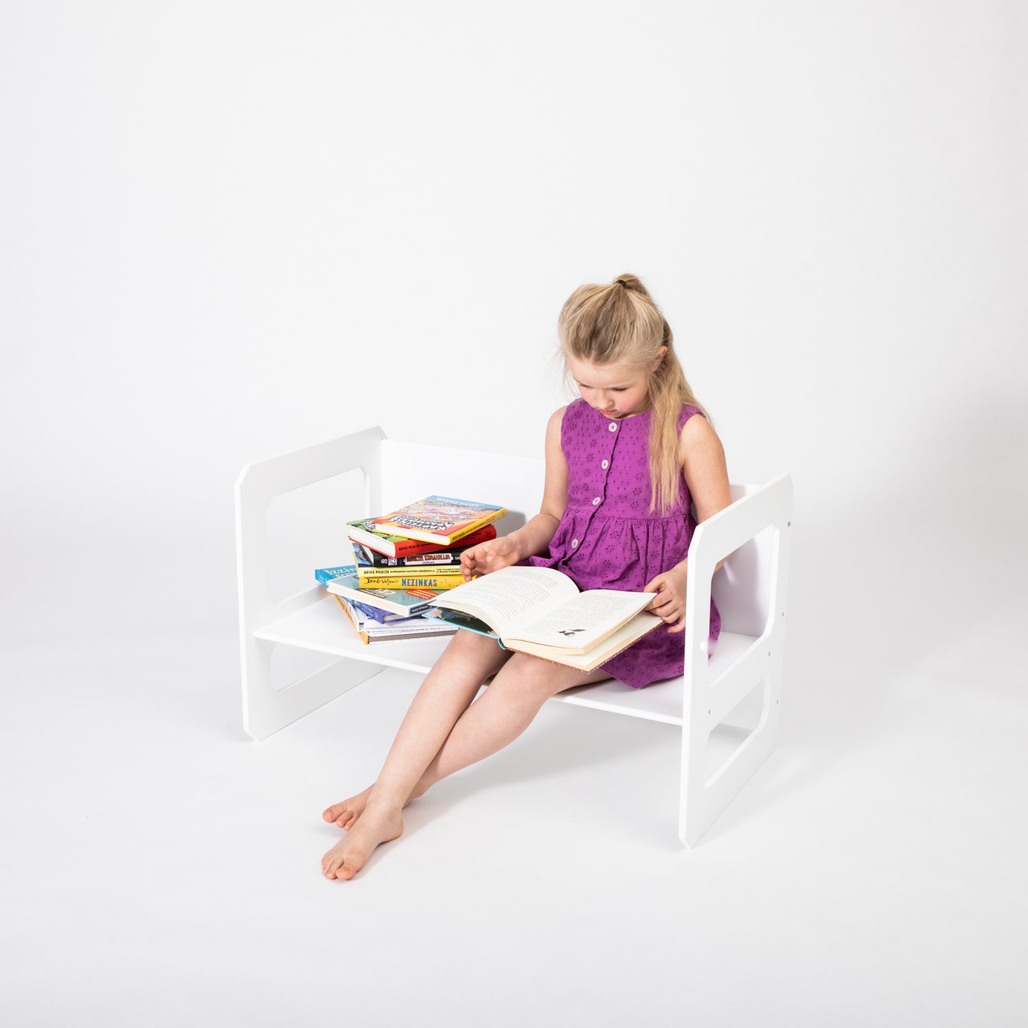 Young girl using white Montessori table for drawing and creative play
