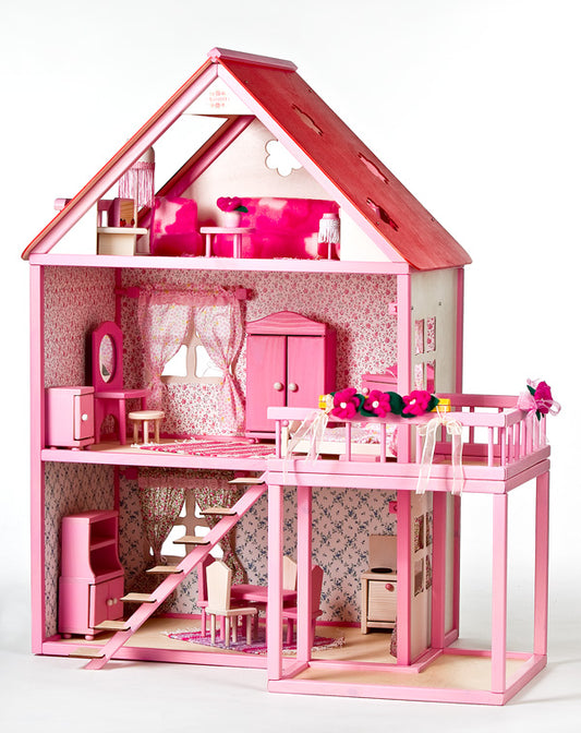 Pink wooden two-storey dollhouse with furnished rooms, balcony, and miniature furniture set