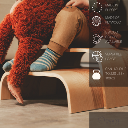 Child using wooden step stool to reach sink with product features displayed