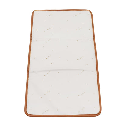 Cream-colored waterproof changing pad with tan vegan leather trim included with backpack