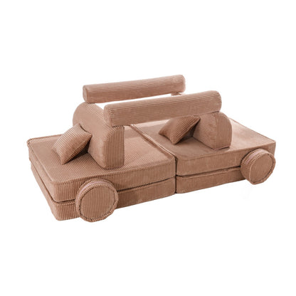 Powder pink modular kids sofa with stacked back cushions and cylindrical wheel-base details, side angle