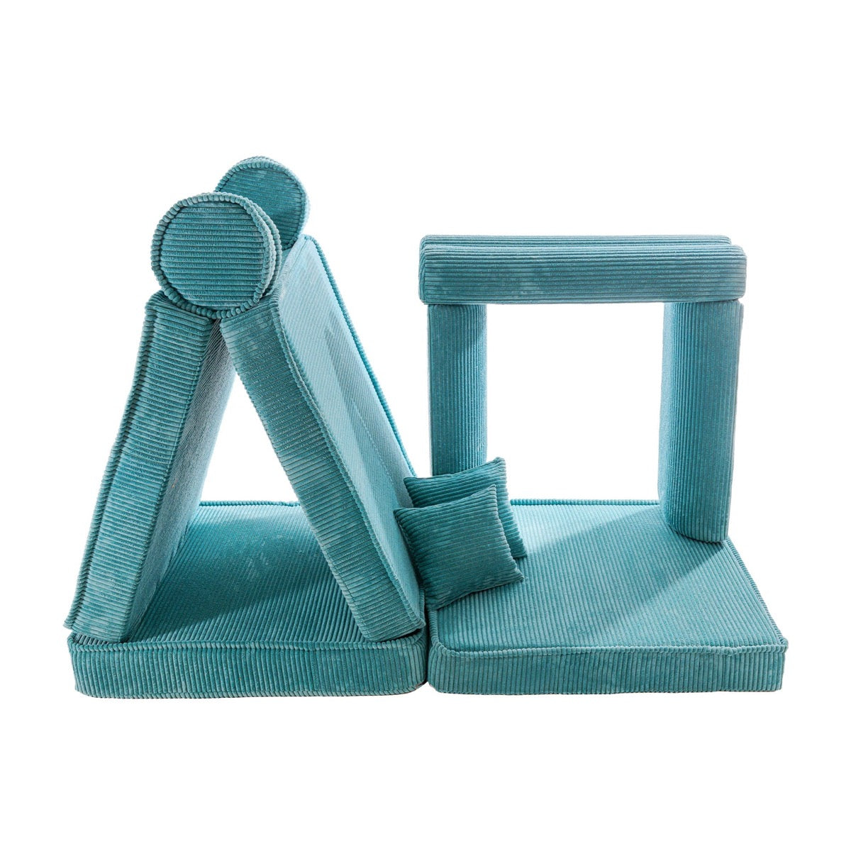 Modular corduroy foam furniture pieces including triangle, cube, and cylindrical cushions in turquoise