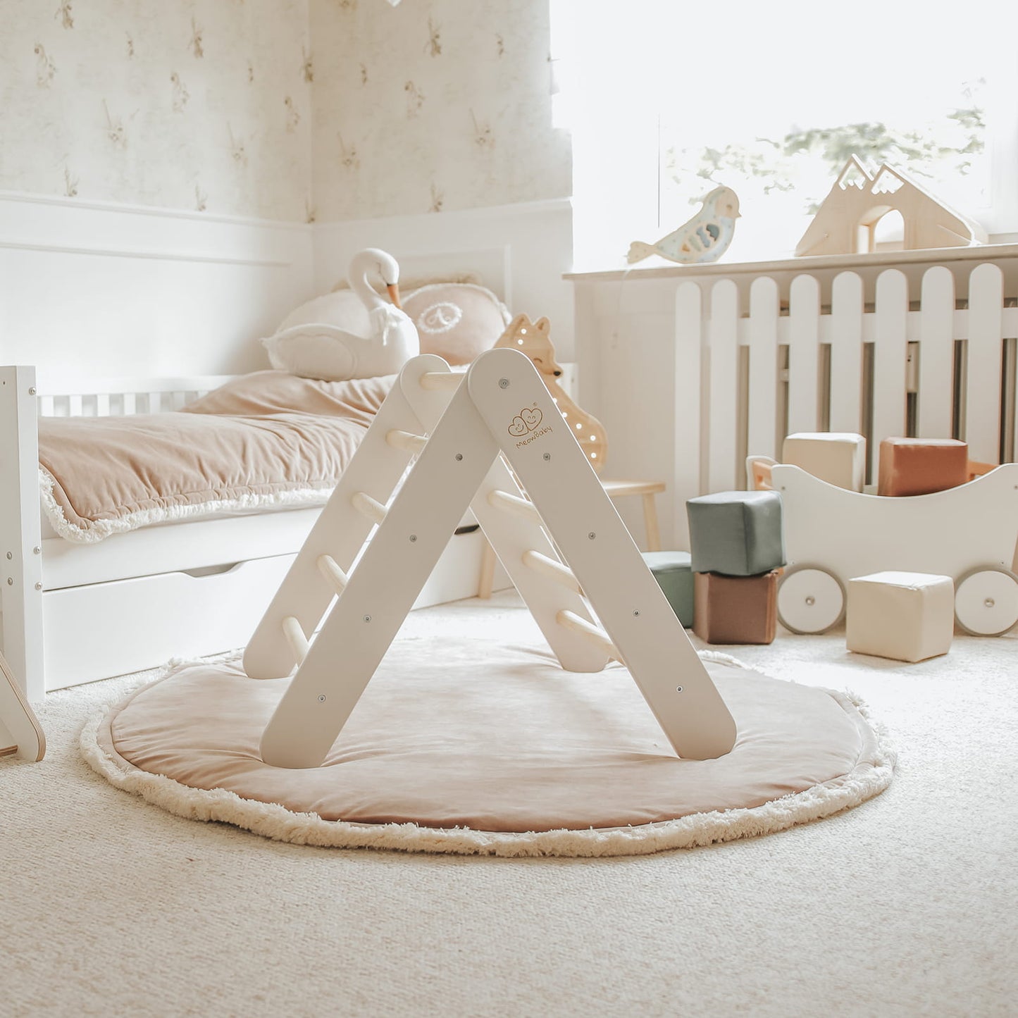 White climbing wall with natural wood ladder indoors in nursery room