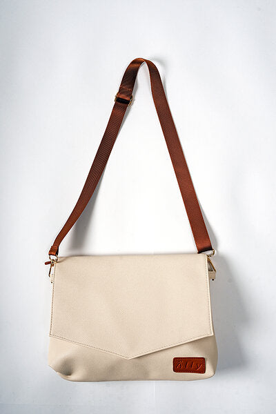 Cappuccino baby handbag front view with long brown shoulder strap and small wrist strap