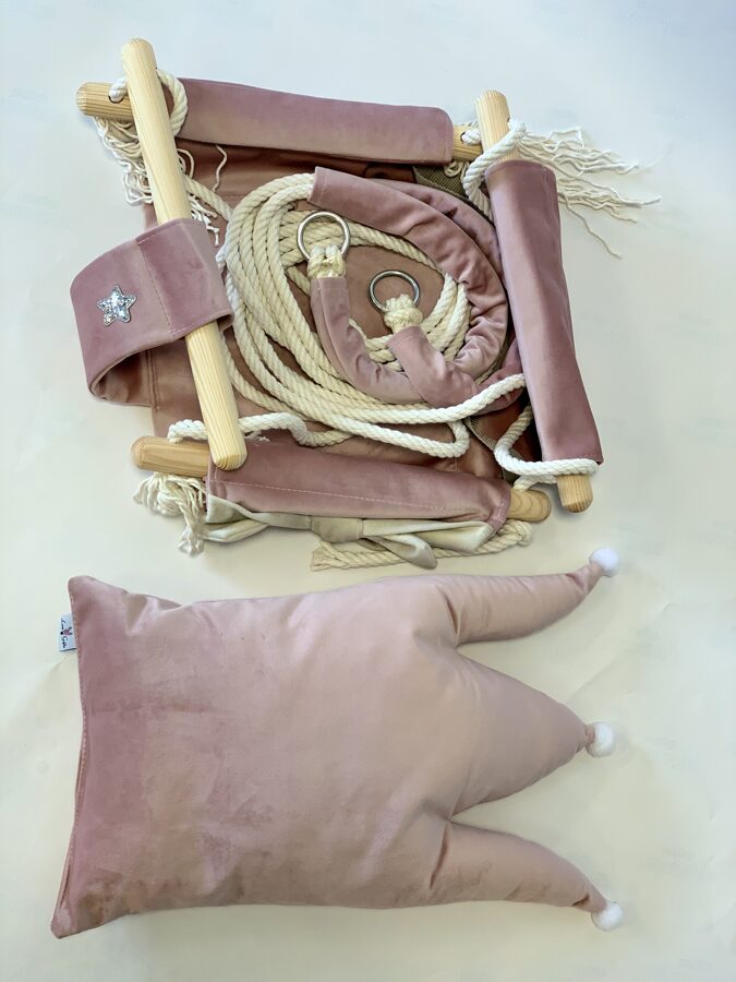 Overhead view of dusty pink crown cushion swing with rope, wooden dowels and star embroidery detail