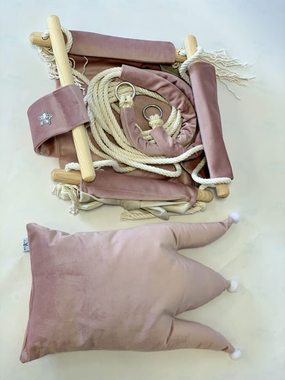 Overhead view of dusty pink crown cushion swing with rope, wooden dowels and star embroidery detail