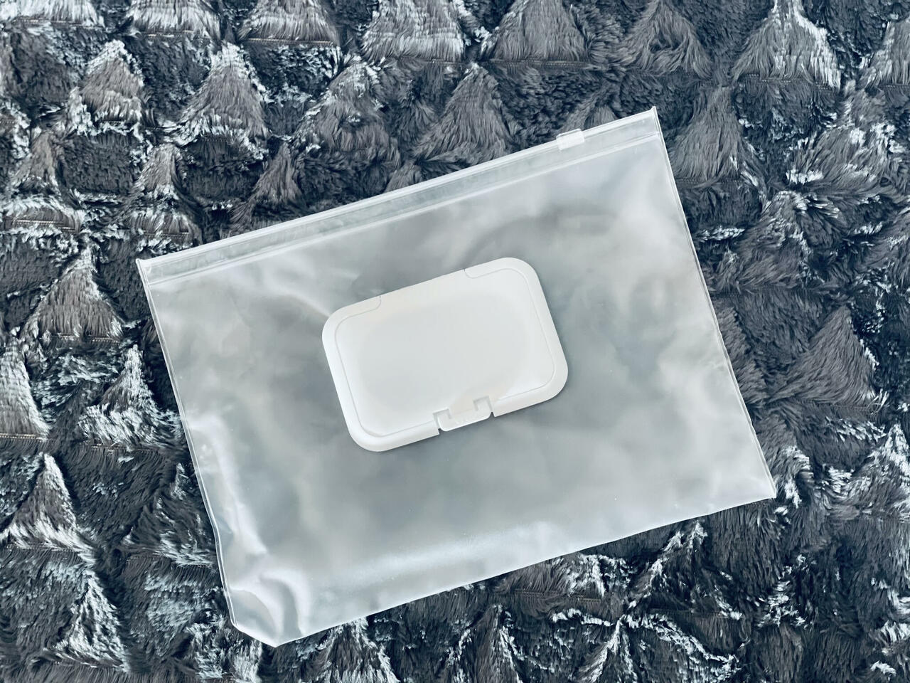 Waterproof clear pouch with white clasp closure for organizing baby essentials