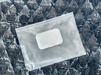 Waterproof clear pouch with white clasp closure for organizing baby essentials