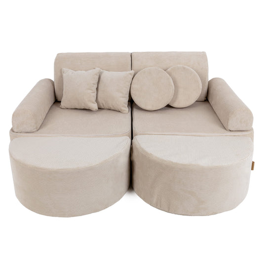 Medium modular kids sofa in ecru slimcord with two curved seats, cylindrical bases, and round accent pillows