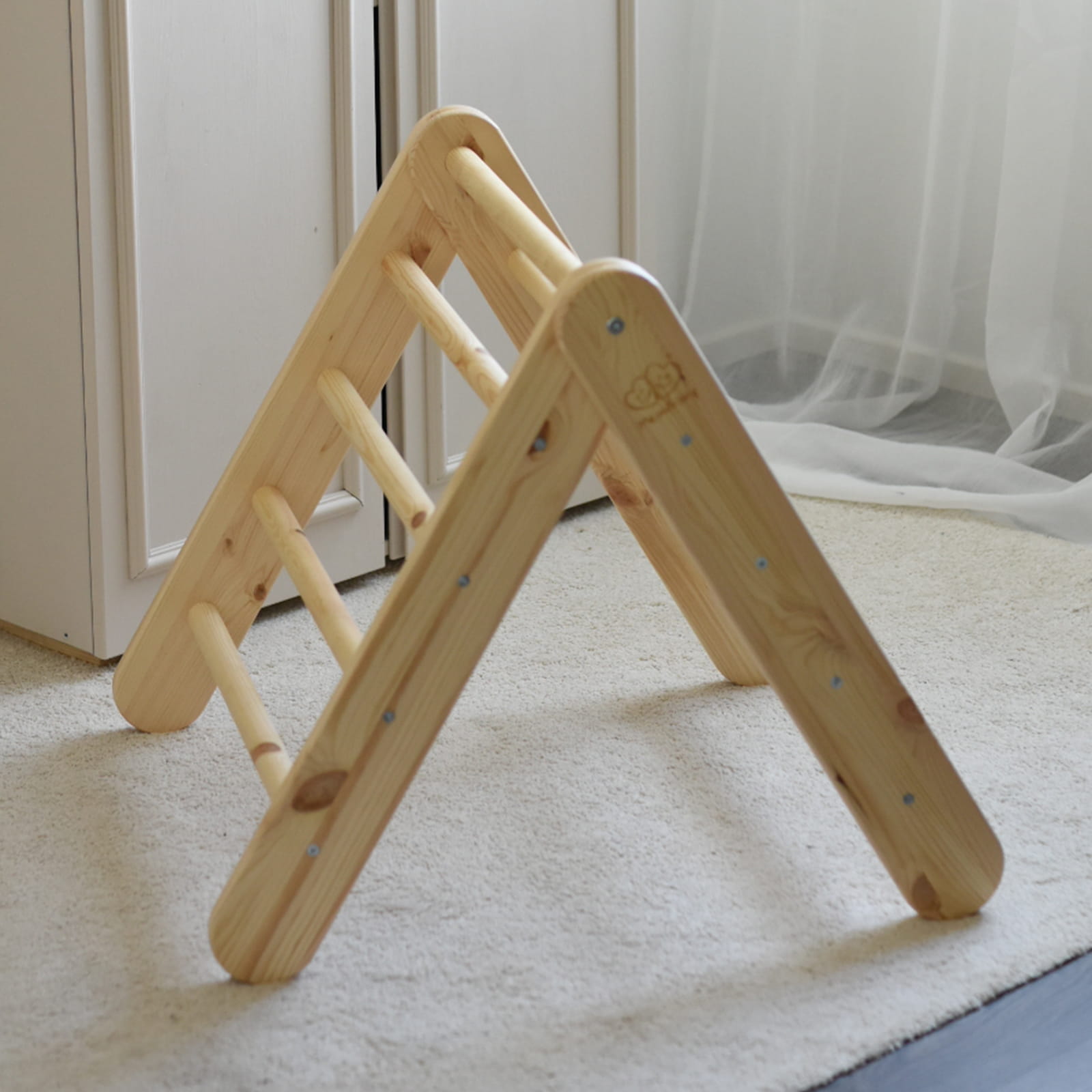 Standalone natural wood ladder with pink tent in modern bedroom