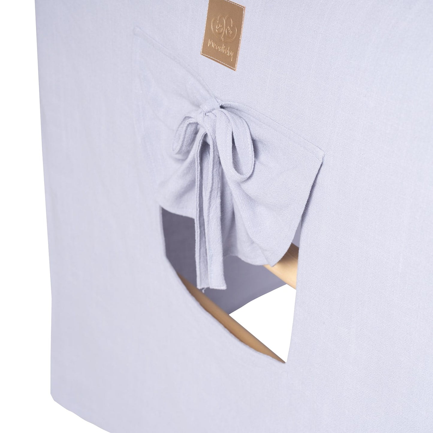 Blue-grey fabric cover detail with window opening and tied fabric closure on ladder house