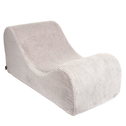 Wave Lounger in ecru, side view highlighting modern curved silhouette and ribbed fabric