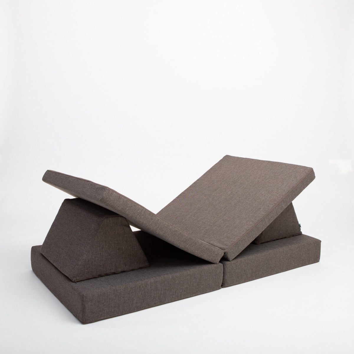 Dark brown foam furniture showing angled pieces in play configuration with varied positioning
