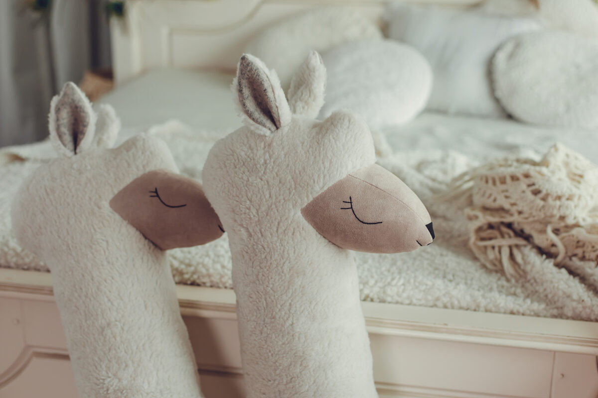 Close-up of vegan fur texture and eco suede face detail on giant plush alpaca – handmade quality
