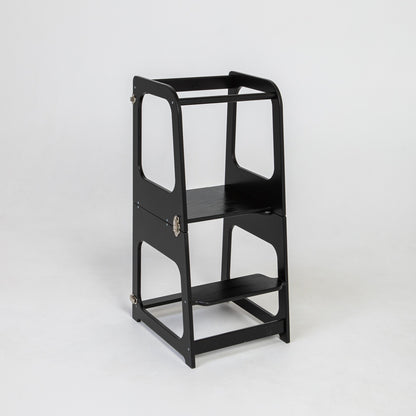 Black learning tower standing upright with safety rails