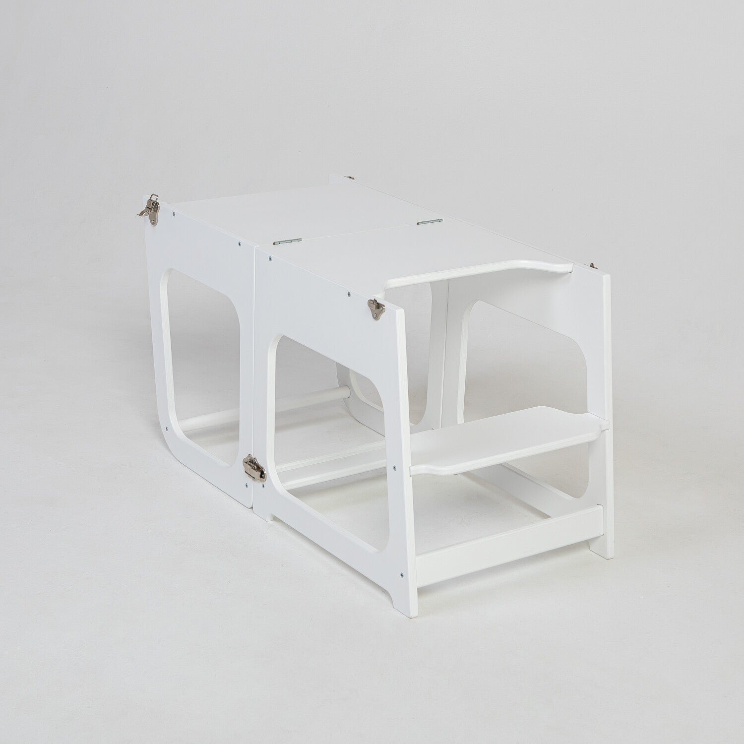 White kitchen tower transformed into table and seating configuration