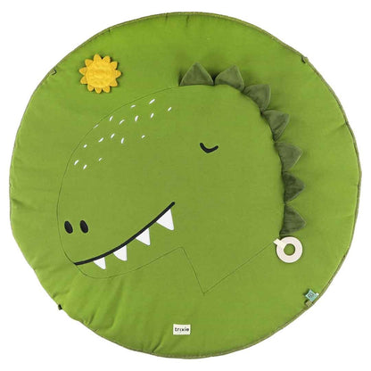 Close-up of green Mr Dino play mat showing dinosaur face with flappy ears, yellow flower toy, and white ring
