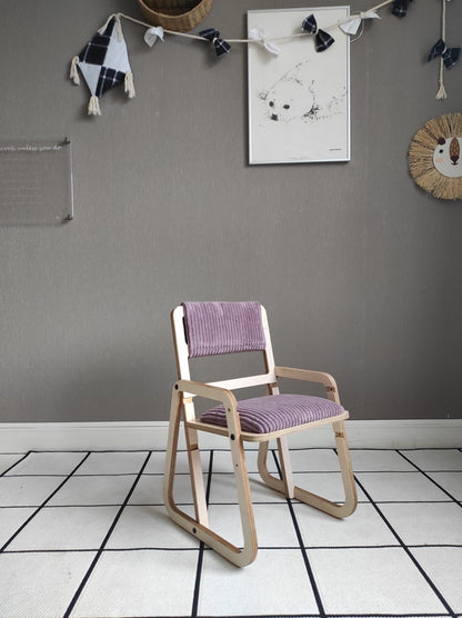 Cannon pink Montessori chair in room setting with artwork and storage accessories