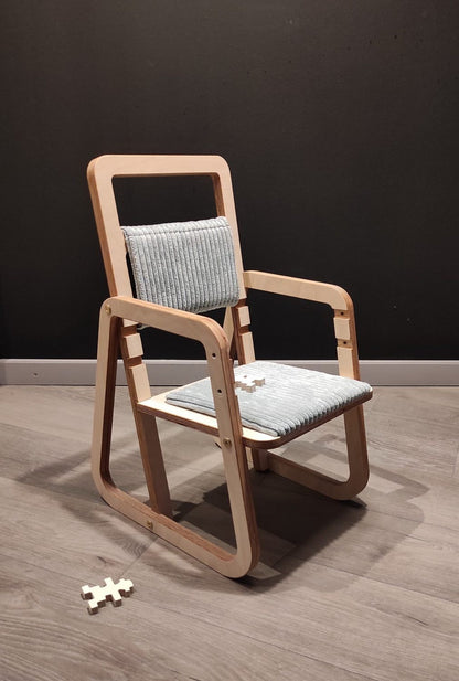 Adjustable Montessori chair with light blue cushioned seat and backrest, front view