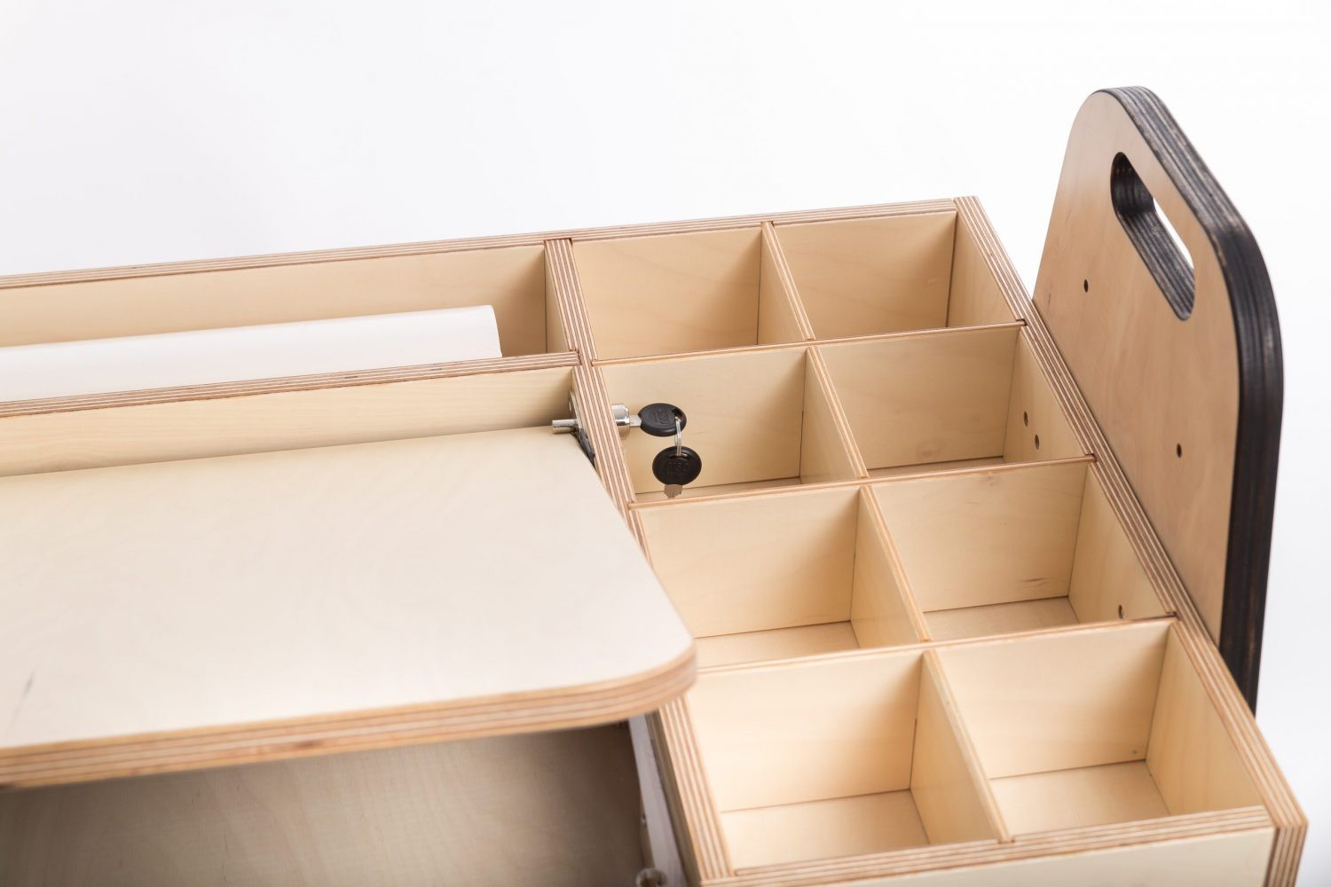 Side view of Montessori table showing compartmentalized storage cubbies and handles