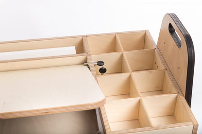 Side view of Montessori table showing compartmentalized storage cubbies and handles