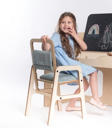 Girl using adjustable birch plywood Montessori desk with blackboard and storage