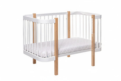 ELIN baby crib in toddler mode showing lower mattress position for growing children