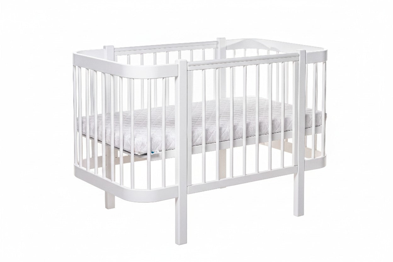 White KOTTO ELIN baby crib with closed side panel and slatted base, front angle view