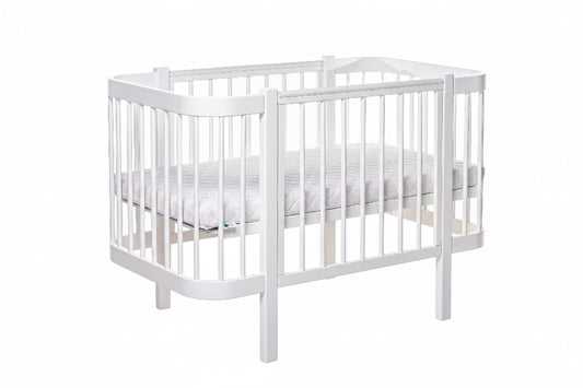 White KOTTO ELIN baby crib with closed side panel and slatted base, front angle view