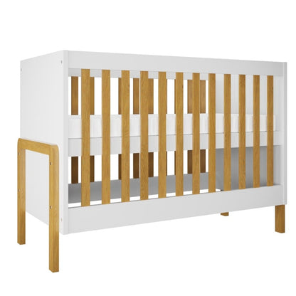 White and natural wood baby crib with oak slats and solid leg supports