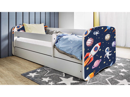 White children's bed with cosmos print headboard and guardrail, storage drawer, and birch slat frame in bedroom setting