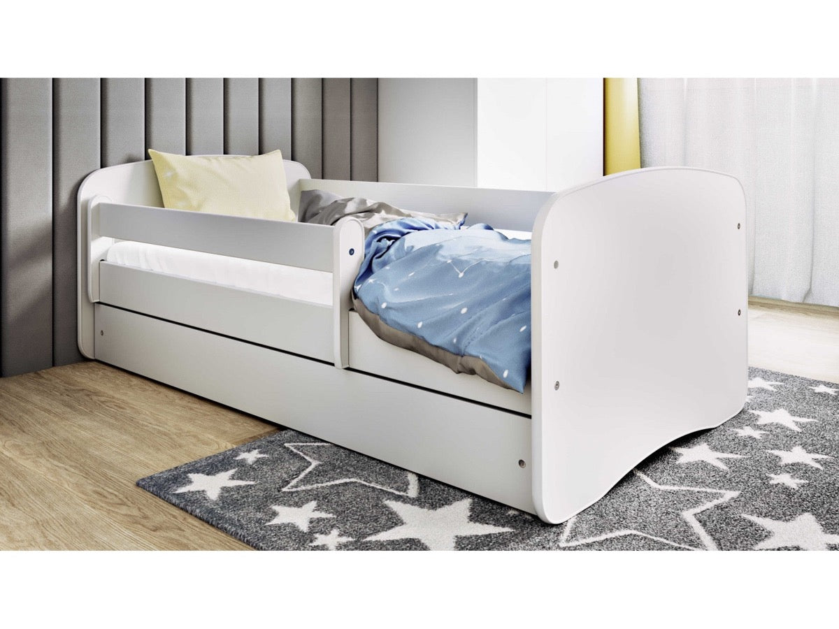 White children's bed in bedroom with blue bedding and storage drawer open