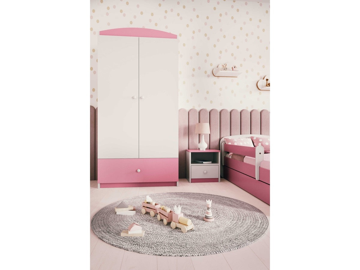 Pink Babydreams wardrobe in child's bedroom with polka dot walls, bed, and round play rug