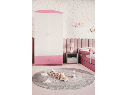 Pink Babydreams wardrobe in child's bedroom with polka dot walls, bed, and round play rug