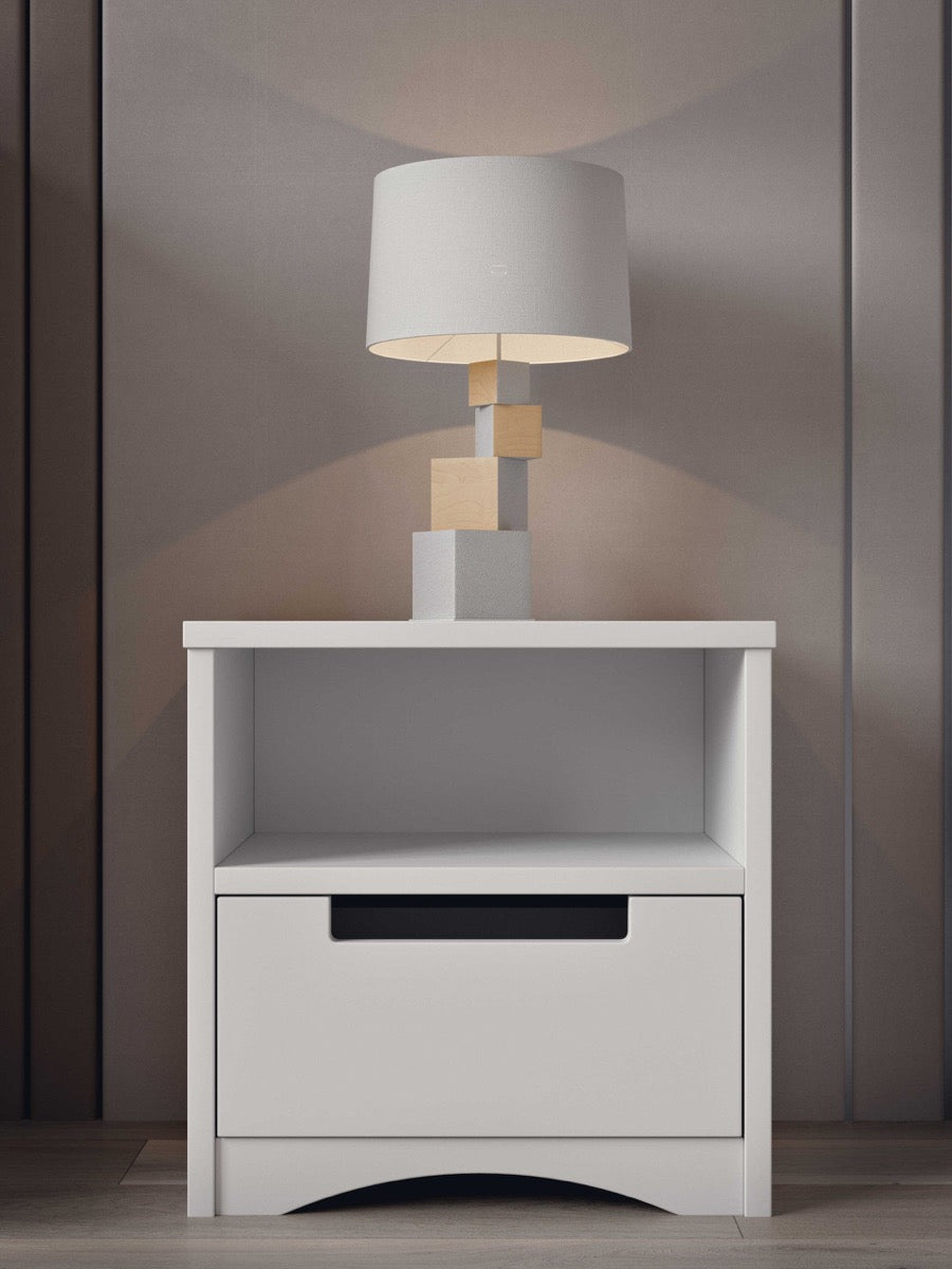 White kids bedside table with lamp and modern design in bedroom setting