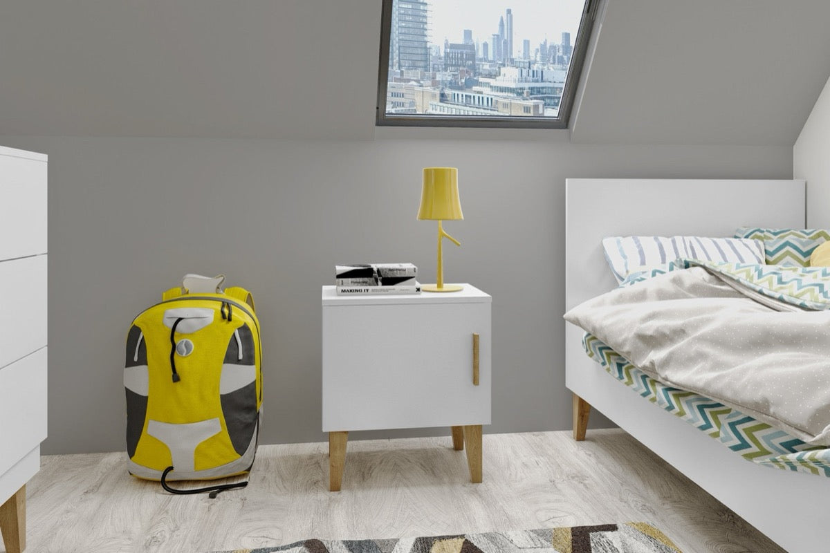 White Kubi nightstand in modern kids bedroom with yellow lamp and backpack