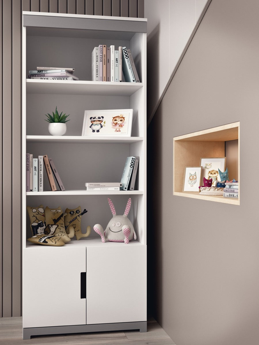 White Tomi bookshelf with four shelves holding books and toys next to wooden floor lamp
