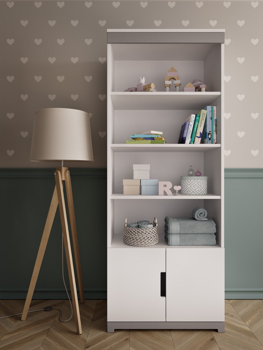 Kocot Kids Tomi bookshelf in white displaying books, toys, and storage baskets in a nursery room setting