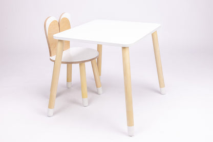 White wooden bunny table with rounded top and natural wood bunny-shaped chair, front view