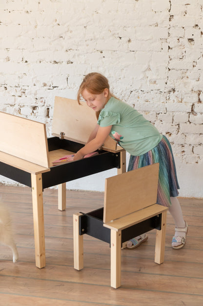 Girl accessing storage compartment in wooden table with flip-open lid design