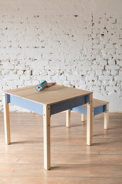 Wooden table and chair set with blue storage compartment and natural finish