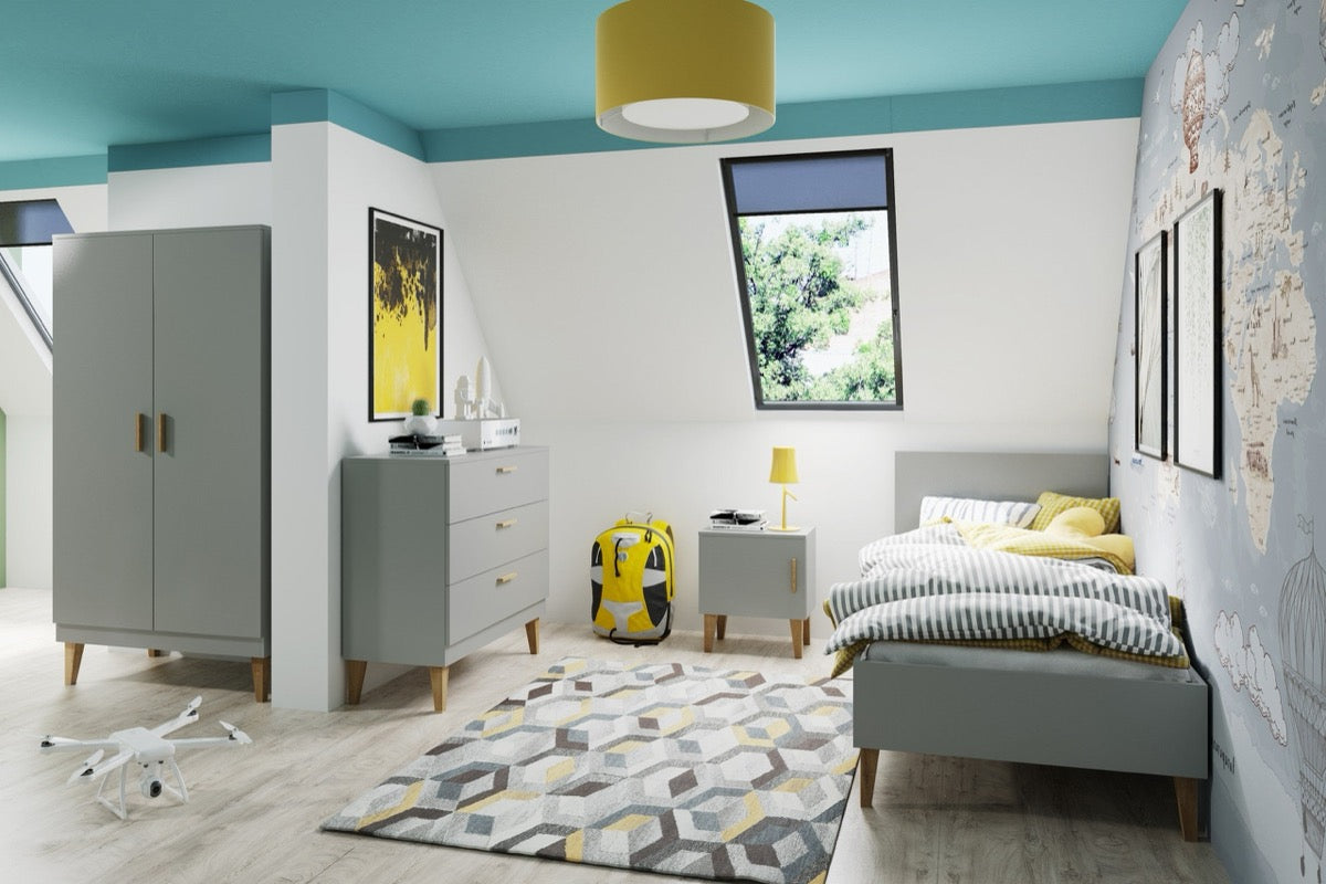 Grey Kubi chest of drawers in nursery room with coordinating wardrobe and bed furniture