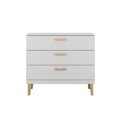 Top-down view of white Kubi dresser displaying three drawers with tan wood handles