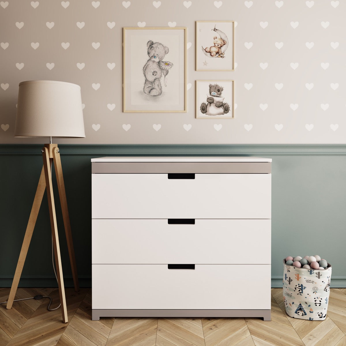 White Tomi chest of drawers with grey accents and black handles in nursery room setting